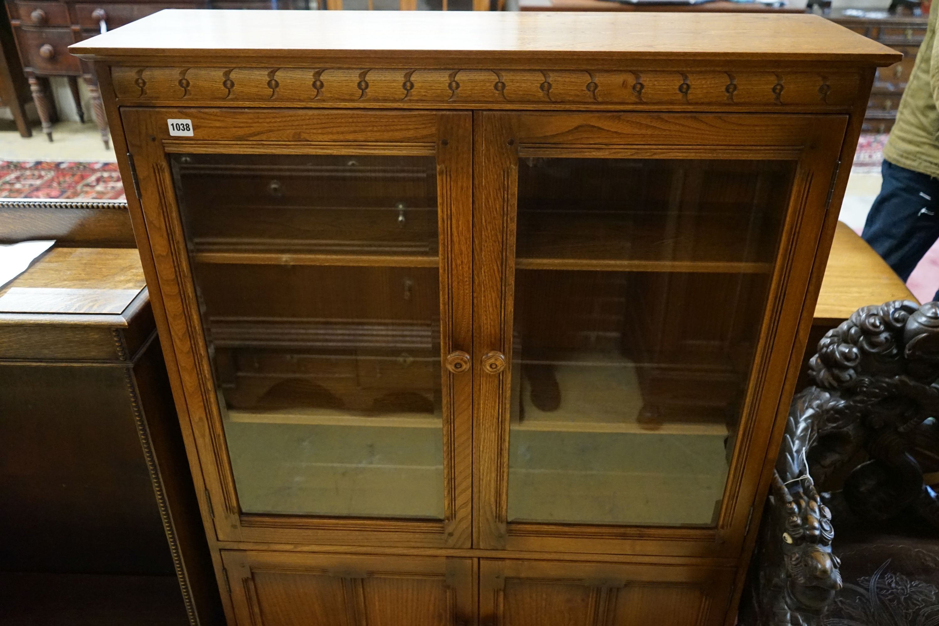 An Ercol elm bookcase, length 101cm, depth 30cm, height 137cm